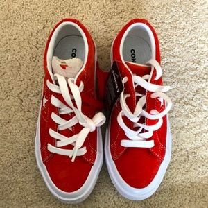 Converse One Star red suede sneakers.
